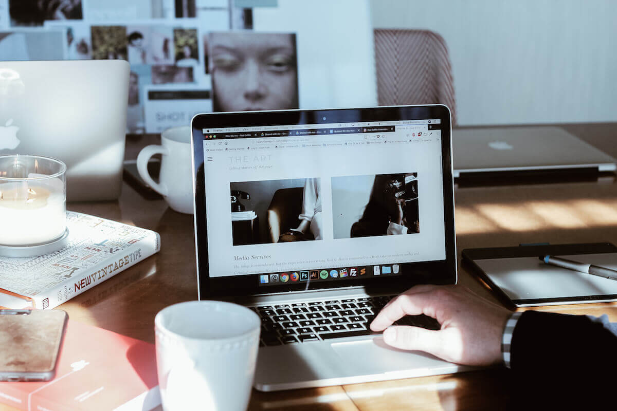 web designer on laptop with coffee