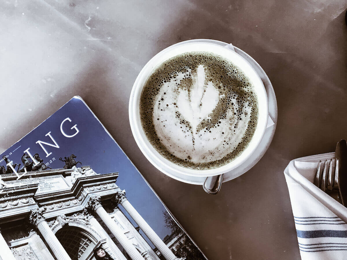 cup of coffee on table with magazine